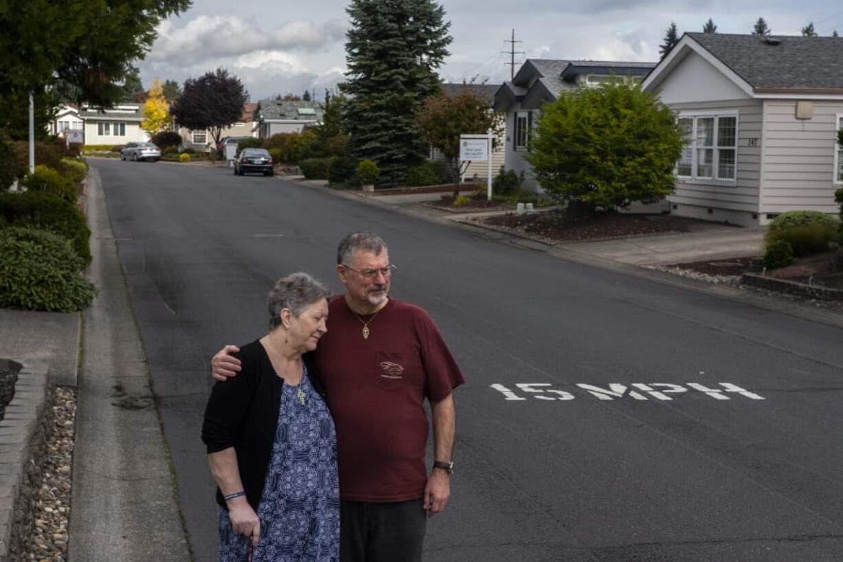 Cheryl and Ken Lickar pose for a photo near their home in Cascade Parks Estates, a 55-and-older manufactured home community where monthly rent is increasing $125 on Jan. 1.