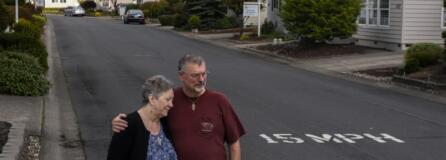 Cheryl and Ken Lickar pose for a photo near their home in Cascade Parks Estates, a 55-and-older manufactured home community where monthly rent is increasing $125 on Jan. 1.