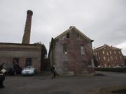 The smokestack at Providence Academy is seen above the ancillary buildings on campus.