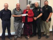 RIDGEFIELD: From Left, Clark County Fire &amp; Rescue Volunteer Smoke Alarm Program Coordinator Tom Cook; CCFR Firefighters Association Treasurer Jack Bothwell; Price Foundation Executive Director Kay Dalke-Sheadel; Clark County Fire &amp; Rescue Fire Chief John Nohr; and Fire Commissioner Stan Chunn stand with a $7,830 grant check that will be used for a supply of smoke alarms.