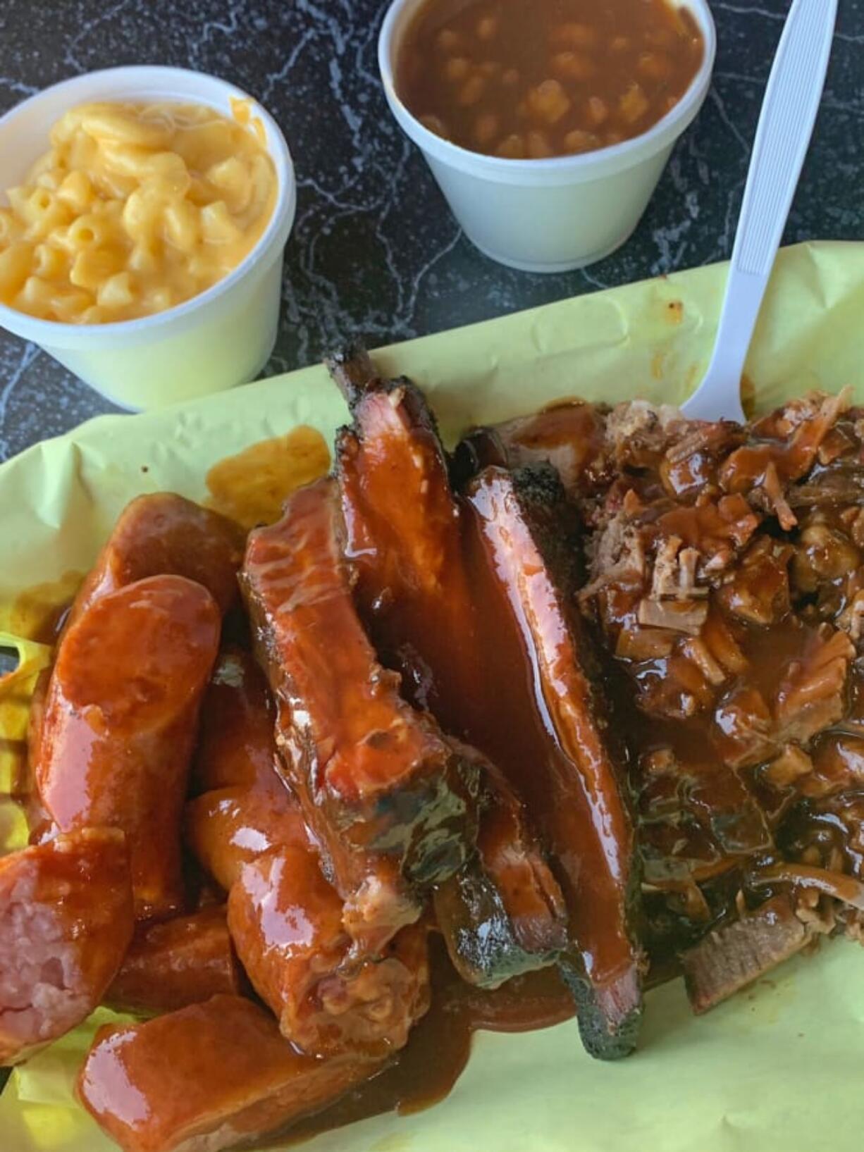 Pork ribs, chopped brisket and hot links with macaroni and cheese and baked beans at Goldie&#039;s Texas Style BBQ.