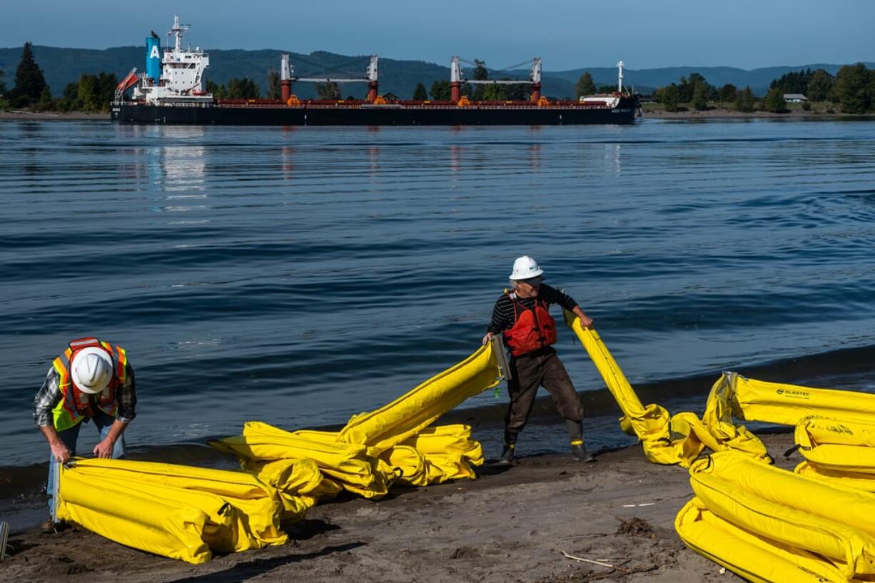 Project Manager Dale Raymond, left, and Technician Peter Siegel assemble a containment boom during a twice-a-year oil spill drill at Frenchman's Bar on Wednesday, Oct. 2, 2019. The drill, coordinated by Union Pacific, with the help of the Washington State Department of Ecology and other water management groups, simulated the first few hours of an oil spill response along the banks of the Columbia River.