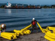 Project Manager Dale Raymond, left, and Technician Peter Siegel assemble a containment boom during a twice-a-year oil spill drill at Frenchman's Bar on Wednesday, Oct. 2, 2019. The drill, coordinated by Union Pacific, with the help of the Washington State Department of Ecology and other water management groups, simulated the first few hours of an oil spill response along the banks of the Columbia River.