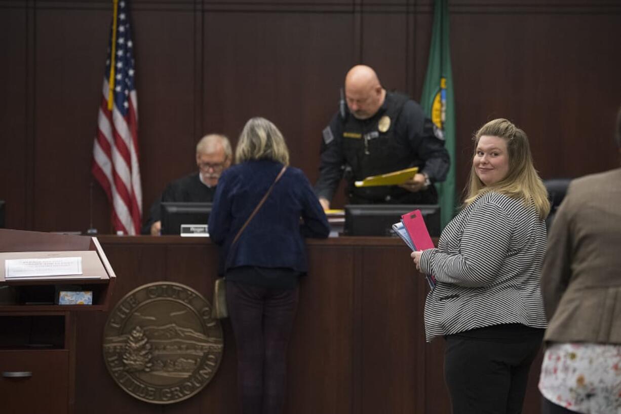 Battle Ground City Attorney Christine Hayes, in stripes, works with court staff Thursday at Battle Ground Municipal Court. The city&#039;s court has seen its workload increase, leading the city to hire Hayes as a full-time attorney.