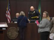 Battle Ground City Attorney Christine Hayes, in stripes, works with court staff Thursday at Battle Ground Municipal Court. The city&#039;s court has seen its workload increase, leading the city to hire Hayes as a full-time attorney.