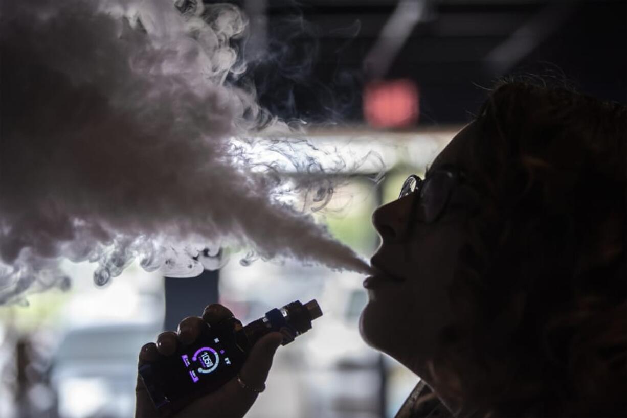 Kaitlyn Wagner, vape guru at Fatboys Vapor on Chkalov Drive, demonstrates her flavored e-juice.