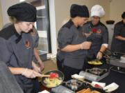 WASHOUGAL: Washougal High School Advanced Culinary students Zoie Petersen, Jovanna White, Ashlyn James and Rebecca McDonald work to serve up pasta to students and faculty on Sept.