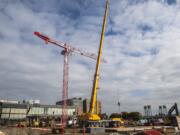 Crews work to assemble a tower crane in downtown Vancouver at the future site of the Aria Apartments on Monday afternoon, Oct. 7, 2019.