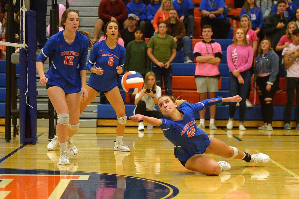 Ridgefield sophomore Morgan Harter is barely able to keep the ball of the floor during a game against Columbia River at Ridgefield High School on Tuesday, October 8, 2019. Ridgefield won all three sets against Columbia River.