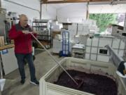 Don Klase mixes wine in a vineyard at Dolio Winery in Battle Ground.