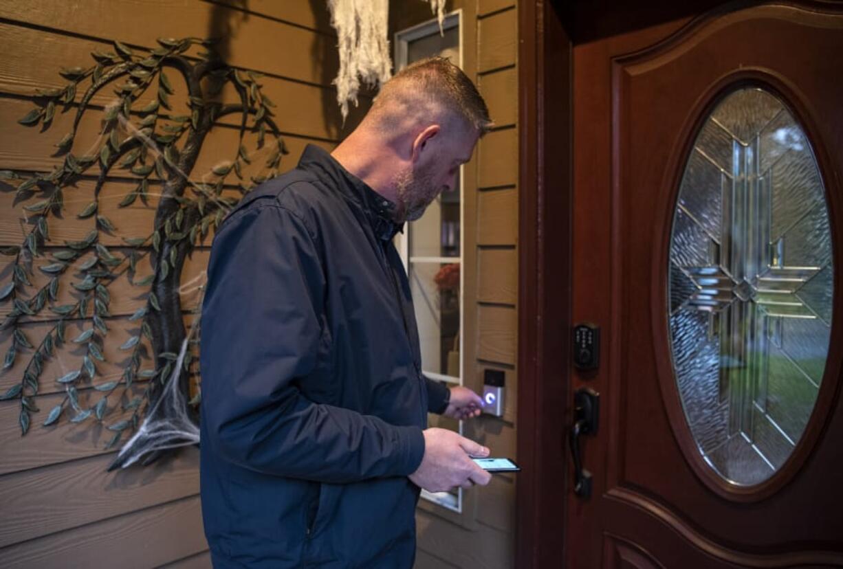 Matt Wiles shows off his Ring camera system at his home in east Vancouver on Wednesday. Wiles was an early adopter of the home camera system and purchased one right after they were released in 2013.