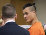 Mitchell Heng talks with his attorneys during his sentencing in the Sifton Market murder-arson Friday in Clark County Superior Court. Heng was sentenced to 31 years in prison.