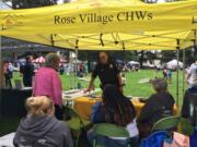 Members of the Rose Village Community Health Work Team speak with local law enforcement and advocate for their community.