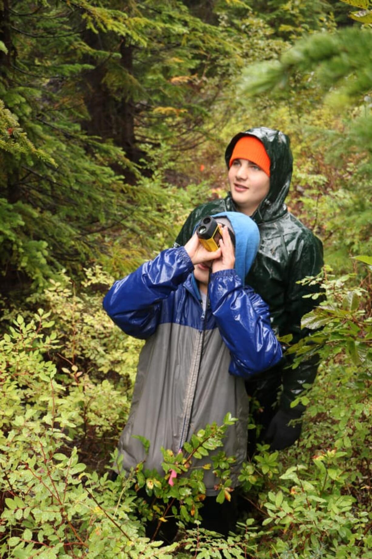 Julian Dobos uses a hypsometer to measure tree heights while classmate Parker Neyens looks on. Students at Battle Ground&#039;s Center for Agriculture, Science and Environmental Education had the opportunity to explore Mount St.