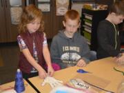 Briley Johnson and Jacob Sanders work together to construct a moving hand.