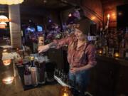 Bar co-owner Annie Maduzia of Vancouver makes drinks at Six Shooter in downtown Vancouver on Oct. 14. Maduzia discovered the vacant restaurant building at 611 Main St. and she and her fellow co-founders thought it would be the perfect location for their vision of a country bar.