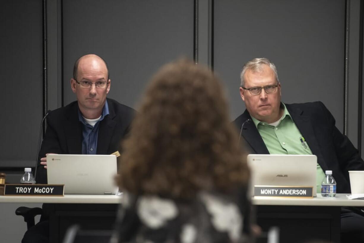 Battle Ground Public Schools directors Troy McCoy, left and Monty Anderson, right, listen to a community member speak in opposition to the adoption of new sex education curriculum meeting on Oct. 14. About 150 people attended the first reading of the sexual health education curriculum Monday, many of whom voiced concerns about the appropriateness of the curriculum.