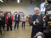 Mechatronics instructor Larry Smith greets guests during a tour at Clark College's Columbia Tech Center campus Monday. The tour was part of the 10th anniversary celebration of the facility.