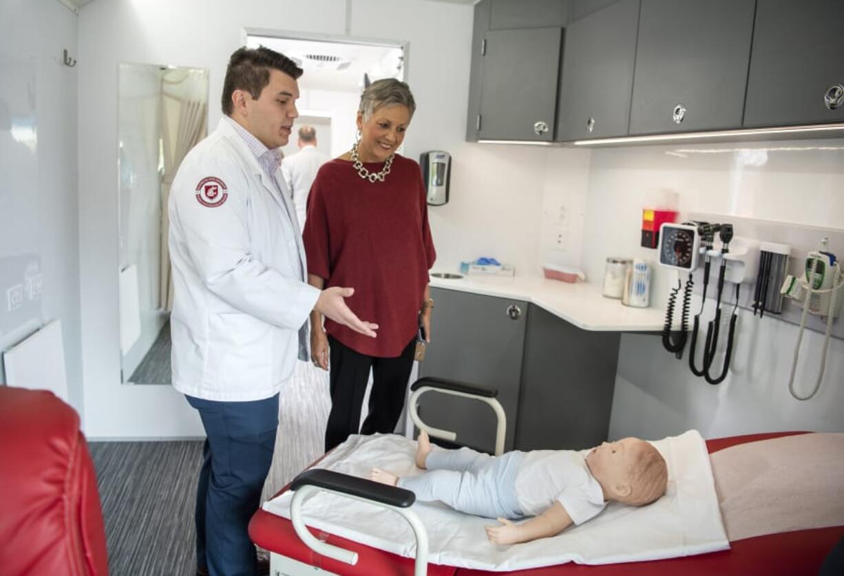 Elson S. Floyd College of Medicine student David Choi, left, gives Sen. Lynda Wilson a tour of Washington State University&#039;s new mobile health clinic, the William A. Crosetto Mobile Health Care Unit, at the Banner Bank east Vancouver branch. It will be an educational resource for medical students as well as a free traveling clinic for small towns throughout Washington.