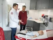 Elson S. Floyd College of Medicine student David Choi, left, gives Sen. Lynda Wilson a tour of Washington State University&#039;s new mobile health clinic, the William A. Crosetto Mobile Health Care Unit, at the Banner Bank east Vancouver branch. It will be an educational resource for medical students as well as a free traveling clinic for small towns throughout Washington.