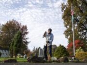 William Zalpys clears away moss buildup on the side of the path at the Fern Prairie Cemetery in Camas. Zalpys has led the cemetery district in the outskirts of Camas since April 2002. He wears many hats in his position, one of which includes groundskeeping, but not grave digging. Cemetery commissioners are elected to six-year terms. Zalpys&#039; term ends in 2023.