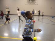 LEADOPTION Jayden Mwaura, 12, takes aim while playing dodgeball with friends during a new after school after-school program for middle school students at the Clark County Family YMCA on Wednesday afternoon. Evergreen Public Schools formally started the new program this year to make sure middle school students have somewhere to go on days they leave school early so staff can meet and train.