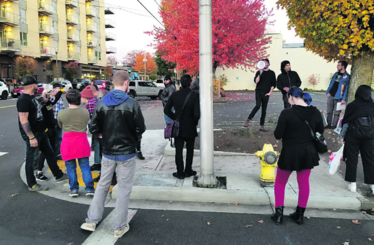 A group of Burgerville employees and their supports picket the chain's Vancouver headquarters Thursday evening. The restaurant and its union will reopen contract talks, ending a four-day strike.