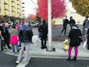 A group of Burgerville employees and their supports picket the chain's Vancouver headquarters Thursday evening. The restaurant and its union will reopen contract talks, ending a four-day strike.