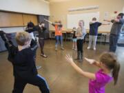 Rachel Jensen, 11, of Vancouver, center, watches as fellow acting students strike a pose during a class for home-schooled kids at the Firstenburg Community Center on Thursday morning. Firstenburg began offering the home-school classes in September, offering supplemental programming to students who are not in traditional school settings.