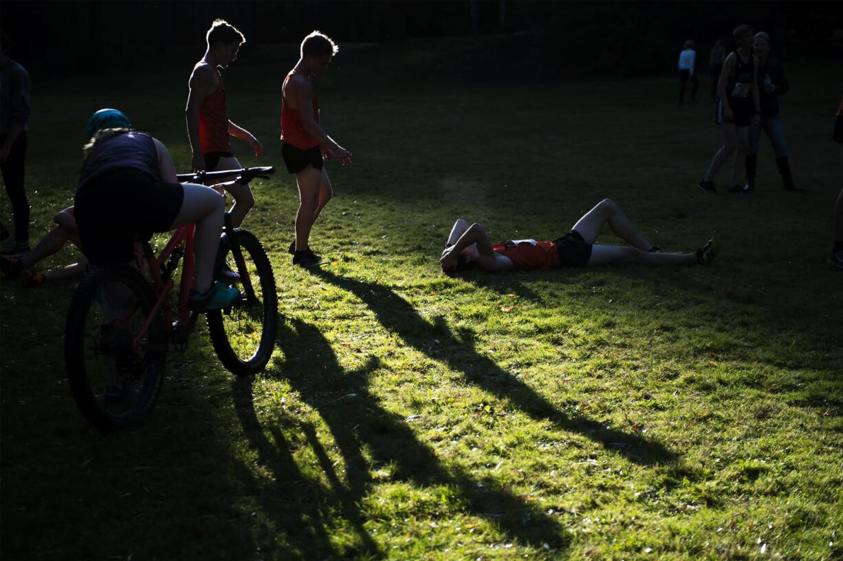 Battle Ground runners rest following the boys 4A district cross country meet at Lewisville Park on Wednesday afternoon, Oct. 23, 2019.