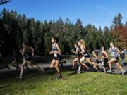 Runners take a turn during the girls 4A district cross country meet at Lewisville Park on Wednesday afternoon, Oct. 23, 2019.