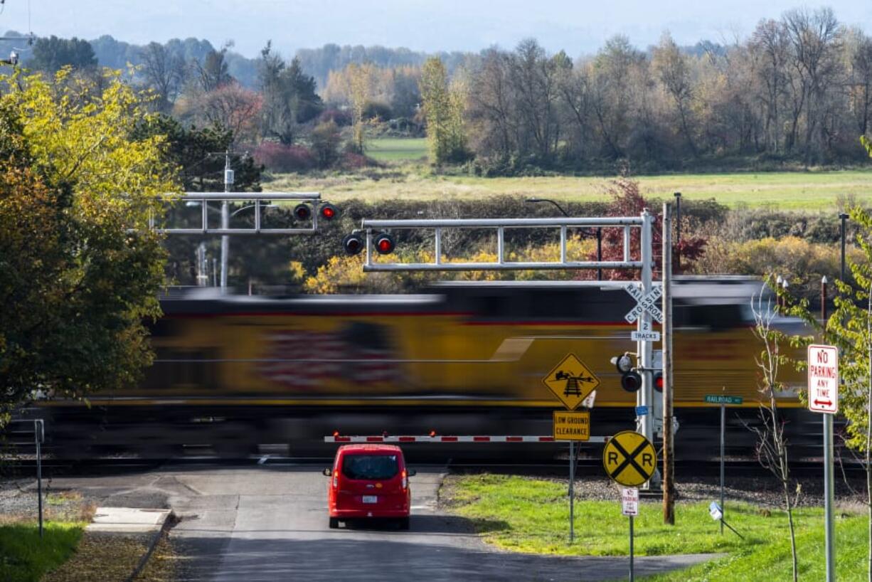 A car waits for a freight train to pass on Mill Street near McCuddy&#039;s Ridgefield Marina on Wednesday.