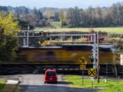 A car waits for a freight train to pass on Mill Street near McCuddy&#039;s Ridgefield Marina on Wednesday.