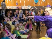 Drag queen Tree Empress 45 Onalicious Mercury asks kids what they want to be when they grow up Sunday at the Drag Queen Story Hour at the Vancouver Community Library. More than 100 children and parents attended the event to sing, dance and listen to storybooks.