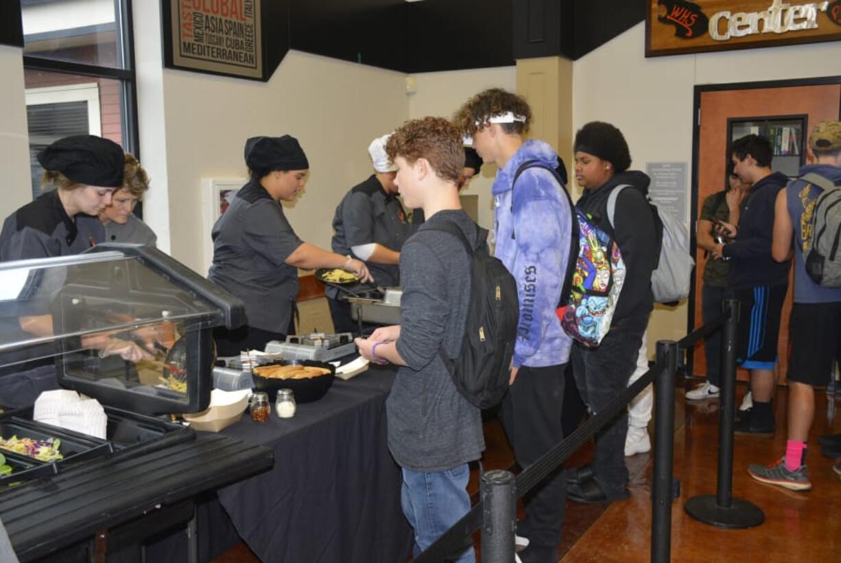 Washougal: Washougal High School culinary arts students Zoie Petersen, left, and Jovanna White serve students during a special lunch at the high school.