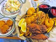 Deep-Fried Pickles, clockwise from left, Midwest-Style Creamy Slaw and Tugboat Combo at Corbett Fish House in Camas.