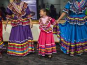 Genesis Cazares, 7, laughs with her fellow Las Bonitas Ballet Folklorico dancers during a celebration of the 200th anniversary of the birth of the Bab at the Water Resources Education Center on Monday night, Oct. 28, 2019.