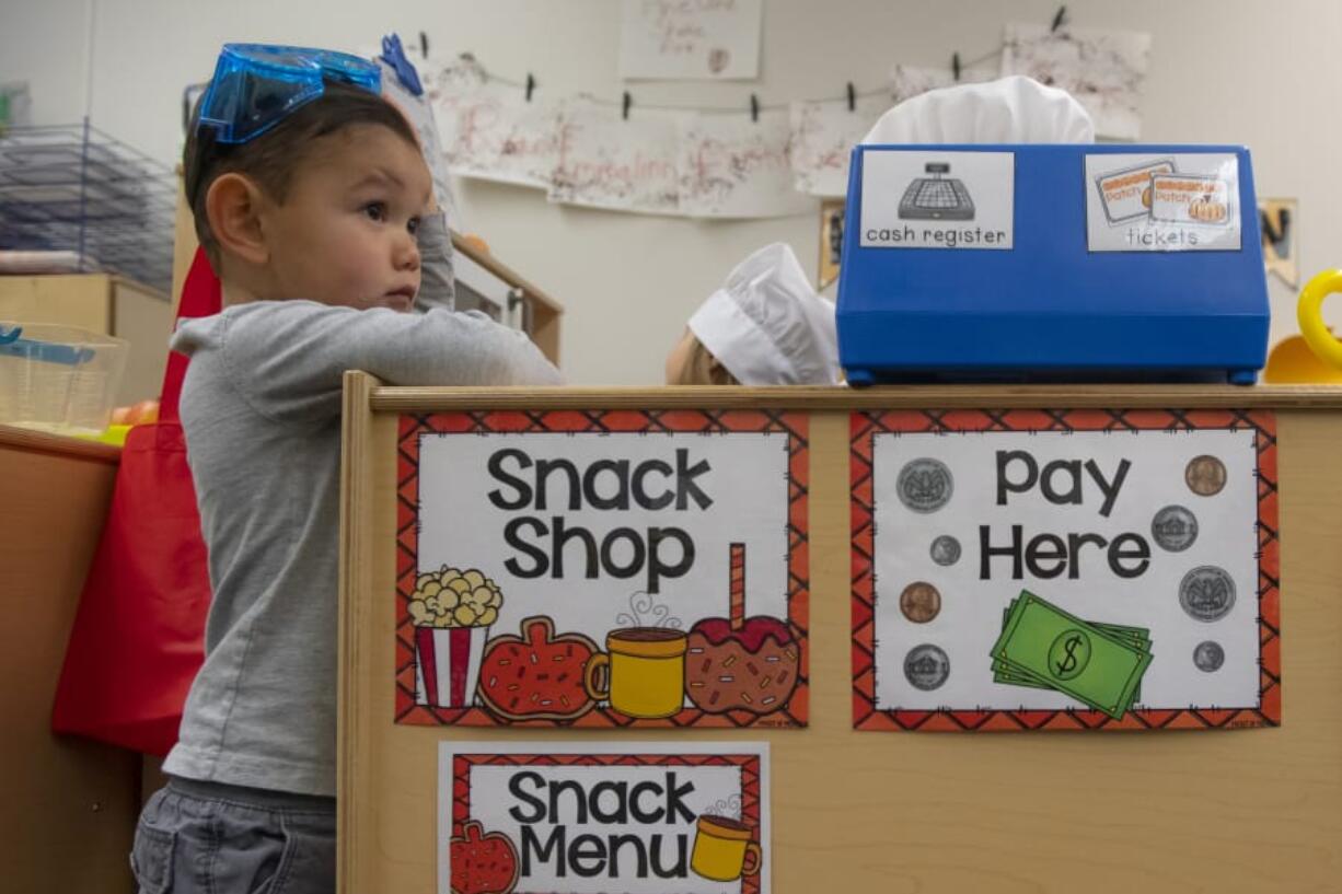 Austin Park, 3, watches a tour as school district patrons visit his class in the Early Learning Center at the Ridgefield Administrative and Civic Center.