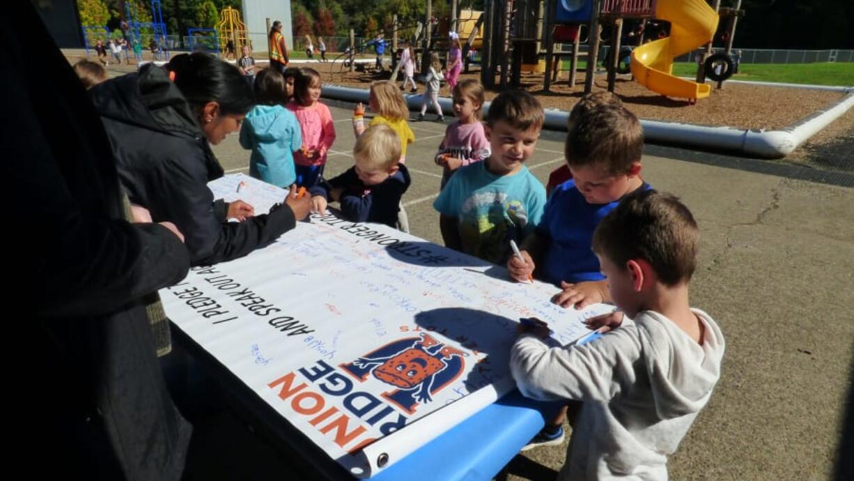 RIDGEFIELD: Union Ridge Elementary School students sign the school&#039;s anti-bullying banner as a pledge to take a stand against bullying during National Bullying Prevention Month.