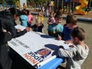 RIDGEFIELD: Union Ridge Elementary School students sign the school&#039;s anti-bullying banner as a pledge to take a stand against bullying during National Bullying Prevention Month.