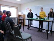 BATTLE GROUND: Horizon Airlines pilot Darin Chung, Portland International Airport Operations Manager Sterling Kesler, and Port of Portland Environmental Specialist Nick Atwell listen as River HomeLink students present possible solutions to the problem of bird strikes.