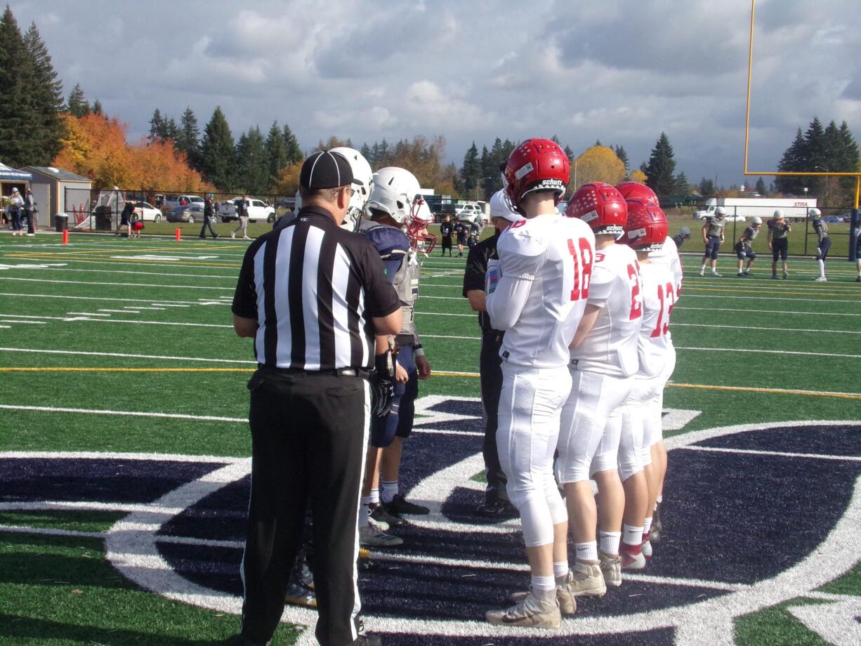 Captains for Seton Catholic and Castle Rock meet for the coin toss prior to their game Saturday at Seton Catholic (Tim Martinez/The Columbian)