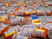 Protesters dropped hundreds of fake prescription bottles of OxyContin during a demonstration last month in front of Purdue Pharma headquarters in Stamford, Conn. Purdue is the manufacturer of OxyContin.