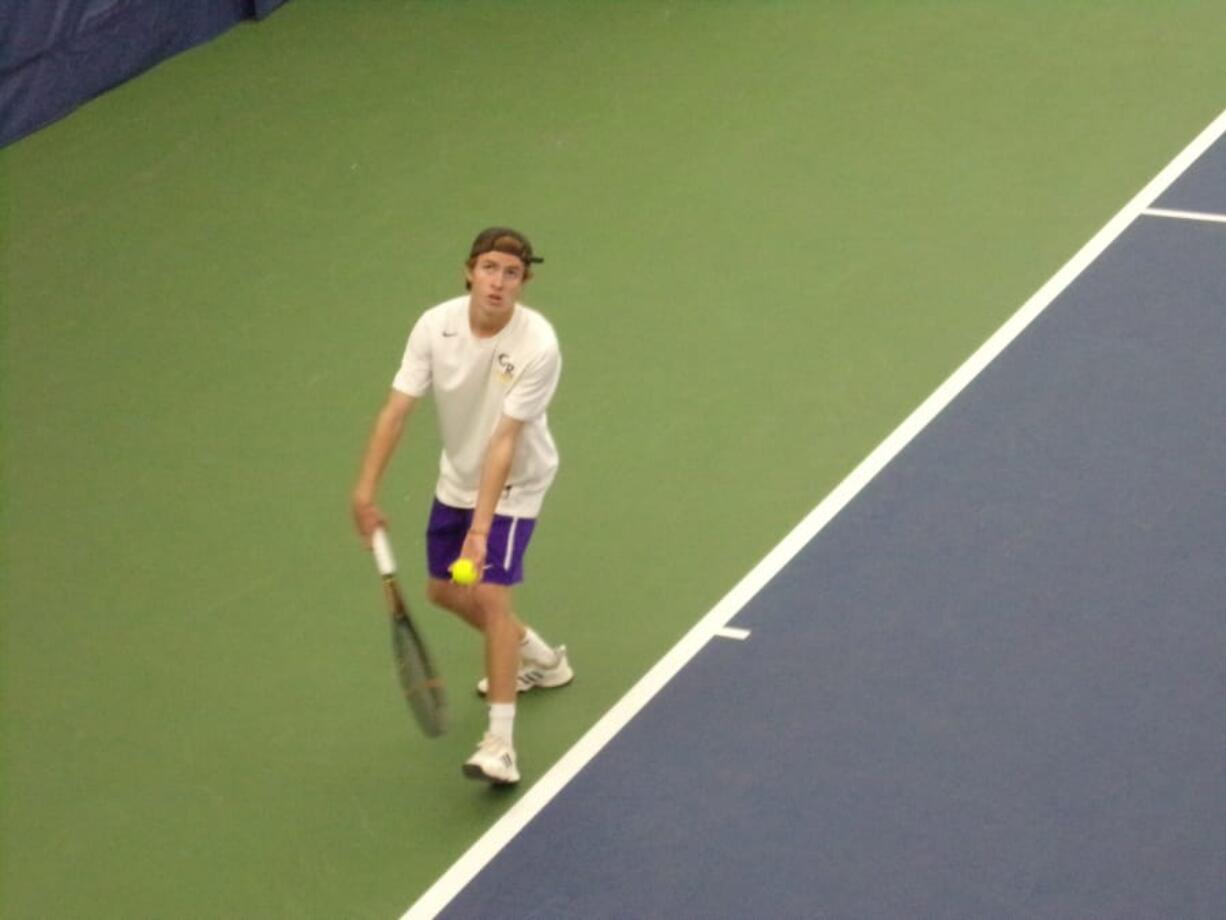 Columbia River's Wilson Keller prepares to serve in his 2A sub-district singles final against teammate Matt Rudi on Saturday, Oct.