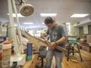 Scott Beaty makes a guitar at the Appalachian School of Luthiery in Hindman, Ky. The school has a program that trains people in drug recovery to make string instruments. (Ryan C.