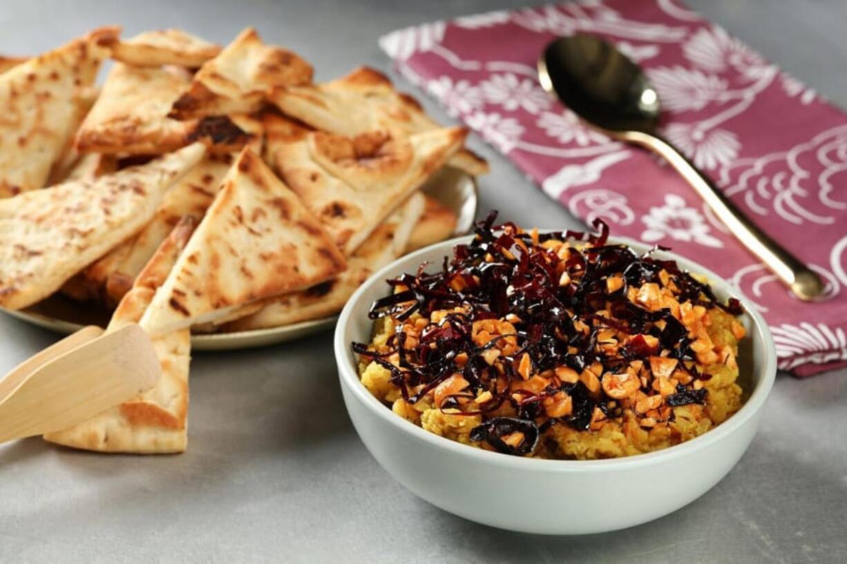 Naan wedges with red lentil and peanut dip.