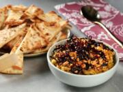 Naan wedges with red lentil and peanut dip.