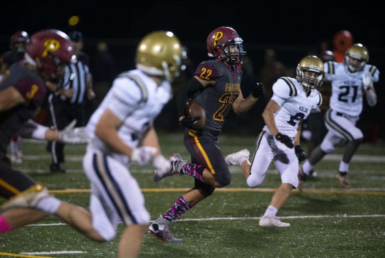 Prairie&#039;s Dustin Shelby (22) runs an 80-yard touchdown during Friday night&#039;s game at District Stadium in Battle Ground. Prairie beat Kelso 38-22.