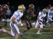 Prairie&#039;s Dustin Shelby (22) runs an 80-yard touchdown during Friday night&#039;s game at District Stadium in Battle Ground. Prairie beat Kelso 38-22.