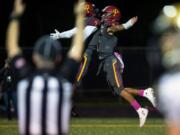 Prairie's Jimmie Barton (2) and A.J. Dixson (5) celebrate a touchdown during Friday night's game at District Stadium in Battle Ground on Oct. 4, 2019. Prairie won 38-22.